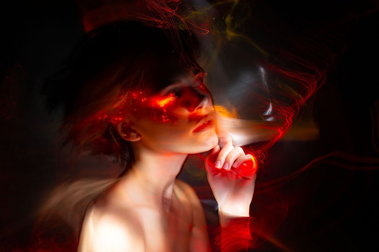 woman with red and white magic wisps surrounding her